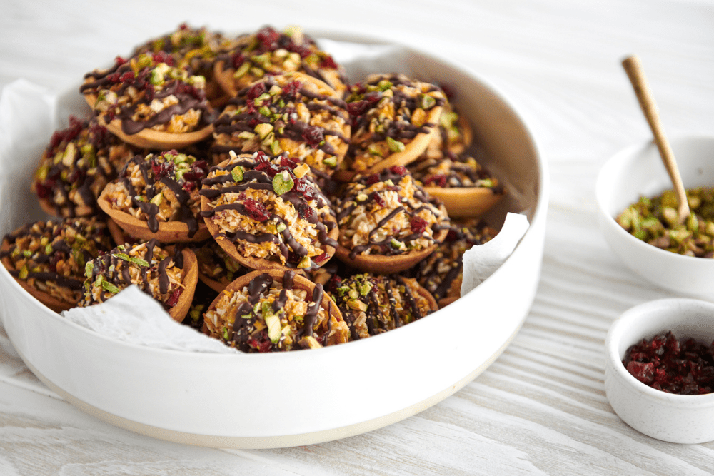 These fruity, nutty delights are encased in sweet, crisp, vanilla bean sweet shortcrust pastry and topped with cranberries, pistachios, and lashings of rich, dark chocolate. They’re the perfect gift for the sweet tooths in your life, and a great accompaniment to coffee or red wine at the end of a long Christmas Day.