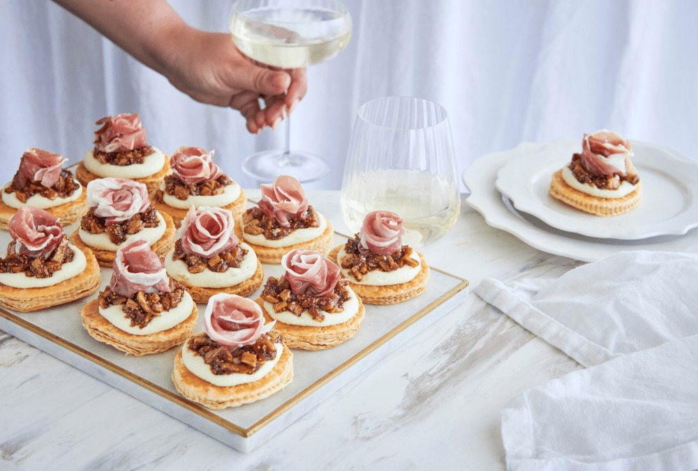 These tasty tarts are an entertaining essential for the festive season. With a base of delicious spelt puff pastry, with a topping of sharp gorgonzola whipped with mascarpone, boozy figs, and prosciutto rose, these tarts will be the toast of the party.